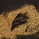 A festive greeting with glitter and cursive lettering spelling 'Happy New Year'. Perfect for seasonal celebrations.